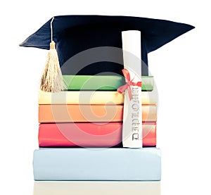 A mortarboard and graduation scroll