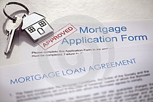 Mortgage application form and loan agreement with house key