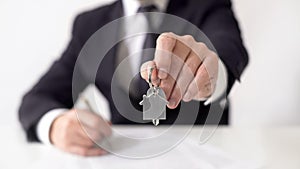 Mortgage broker giving apartment keys to real estate buyer, property contract