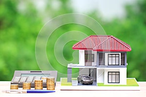 Mortgage calculator, Model house with Miniature car model green background, Interest rates and Real estate concept