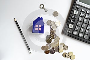 Mortgage concept with stack coins and paper at home and calculator. Economic crisis