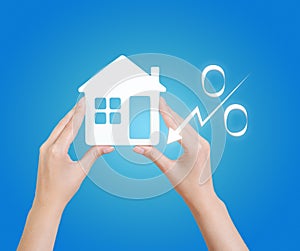 Mortgage concept. Woman holding house model on light blue background, closeup