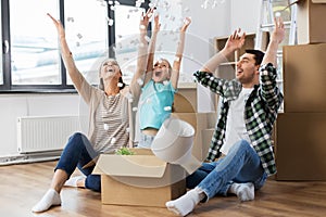 Happy family playing with foam peanuts at new home