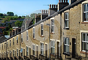 Mortgage and finance housing stock concept. A typical row of Lancashire town stone facade built and slate roof covered terraced ho