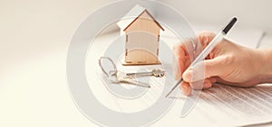 Mortgage and housing rent. Keys, house and hand that signs documents