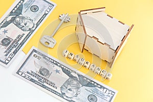 mortgage, insurance, loan and home purchase. Model of house, dollar bills, key on white and yellow isolated background. Free space