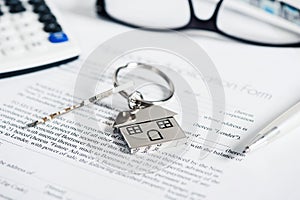 Mortgage loan agreement application with house shaped keyring