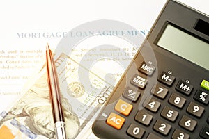 Mortgage loan agreement sign contract concept, pen on US dollar