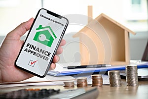 Mortgage Loan approval on mobile phone in a house contract form with approved  home ownership photo