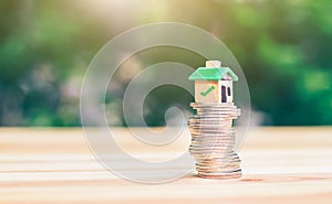 Mortgage and loan approved concept:  house on a coin pile.