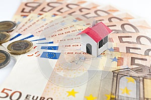 Mortgage and loan concept: paper house on a fifty euros banknote