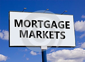 Mortgage markets symbol. Concept words Mortgage markets on beautiful white billboard. Beautiful blue sky white cloud background.