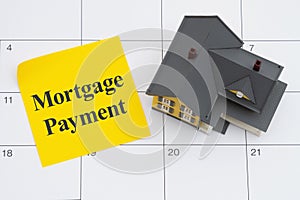 Mortgage payment due with house and sticky note on a calendar