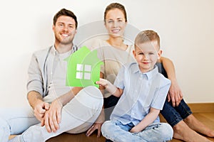 Happy family with green house moving to new home