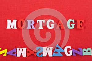 MORTGAGE word on red background composed from colorful abc alphabet block wooden letters, copy space for ad text. Learning english