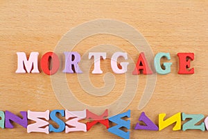 MORTGAGE word on wooden background composed from colorful abc alphabet block wooden letters, copy space for ad text. Learning