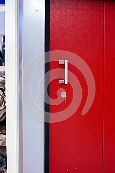 Mortise lock with keys on a red metal door
