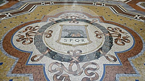 Mosaic of the Capitoline Wolf in the center of the Galleria Vittorio Emanuele II in Milan, Italy`s oldest shopping mall.