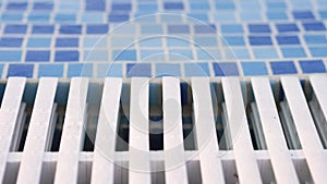 Mosaic side and white grille in blue and white,pool with clear transparent water
