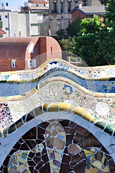 Mosaic tile panorama and Barcelona cityscape in famous park Guell, Spain