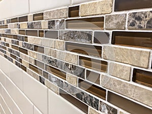 Mosaic tiles made of glass and stone, newly installed on the wall as decoration or kitchen backsplash