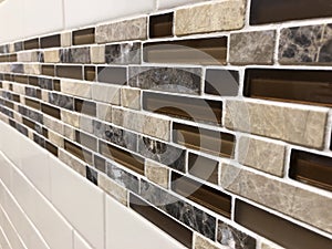 Mosaic tiles made of glass and stone, newly installed on the wall as decoration or kitchen backsplash