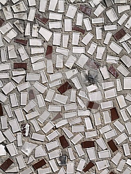 Mosaic tiles on the wall of the house. Architectural abstract background texture. Gray concrete
