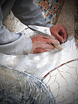 Mosaic Worker lays tiles photo