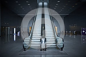Perspective view on metal escalator moving stairs to the second floor in exhibition hall Crocus Expo. Staircase in office business