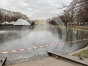 Moscow, a barrier tape to prevent access to thin winter ice on Clean ponds Chistye prudy in abnormally warm weather