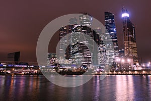 Moscow city night view with skyscrapers and a futuristic bridge