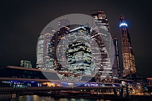 Moscow city night view with skyscrapers and a futuristic bridge