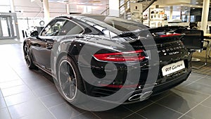 Moscow. February 2018. Black Porsche 911 991 Carrera at dealer showroom. Taillights and aerodynamic spoiler. Back and side view