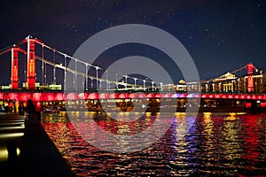 Moscow Kremlin. Night scene. The Moscow river embankment. The bridge over the river is decorated by lights in colors of Russian