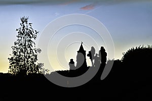 Moscow Kremlin tower and people silhouettes.