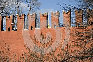 Moscow Kremlin wall at a sunny day. Yellow onion is seen through it.