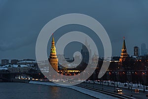 The Moscow Kremlin in the winter night and the Moskva River embankment with a Christmas decoration