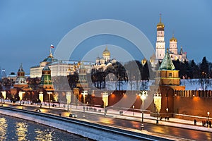 The Moscow Kremlin in the winter night and the Moskva River embankment with a Christmas decoration