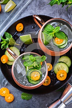 Moscow mule cocktail with lime, mint, cucumber and kumquat