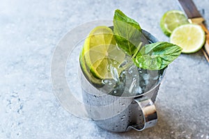 Moscow Mule Cocktail with Lime, Mint Leaves and Crushed Ice in Metal Cup.