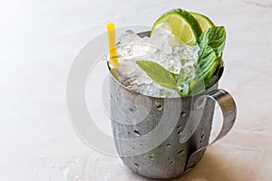 Moscow Mule Cocktail with Lime, Mint Leaves and Crushed Ice in Metal Cup.
