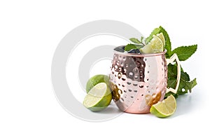 Moscow mule cocktail served with ice and lime slice isolated on white background
