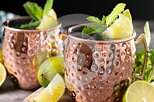 .Moscow mule cocktail served with ice and lime slice on wooden table