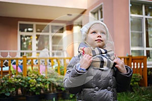 little Girl stands near house at summer residence photo