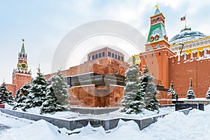 Moscow Red Square in winter, Russia. Lenin`s Mausoleum by Moscow Kremlin under snow