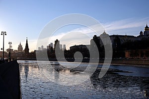 Moscow river, embankment and silhouettes of buildings and towers on sunset