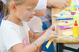 MOSCOW, RUSSIA - April 24, 2019: children and adults at the table do needlework and paint on the street on a sunny day. children`