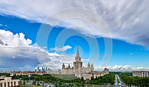 Aerial panoramic view of sunny campus buildings of famous Moscow university under dramatic cloudy sky in spring