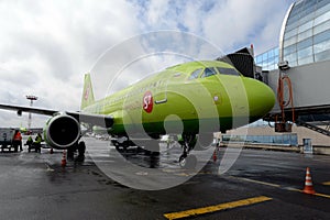 Airbus A319 airplane of S7-Siberia Airlines at a passenger telescopic gangway at Domodedovo International Airport
