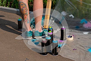 Set of used spray paint cans at summer graffiti festival